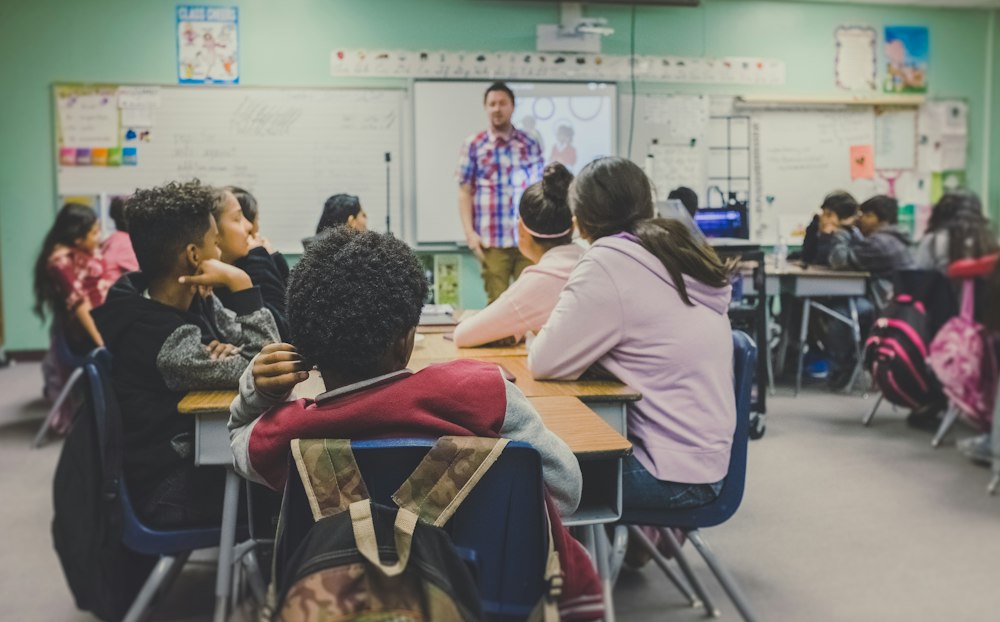 Teacher leading a classroom of children