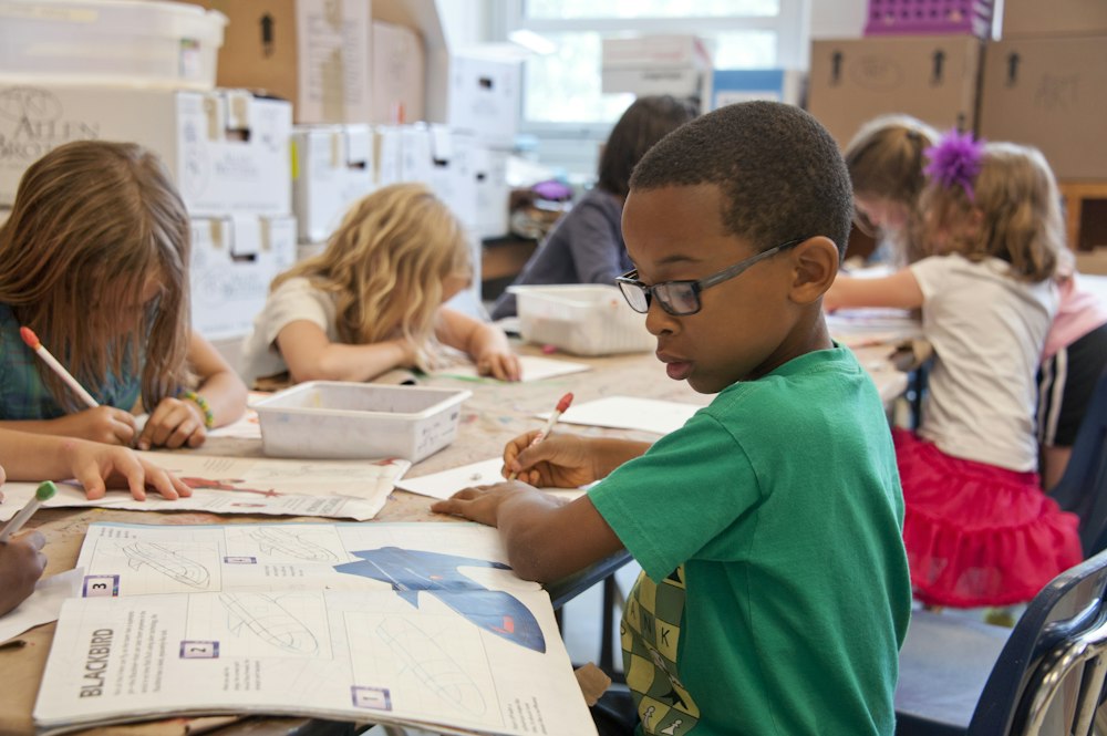 Children doing schoolwork together at a table
