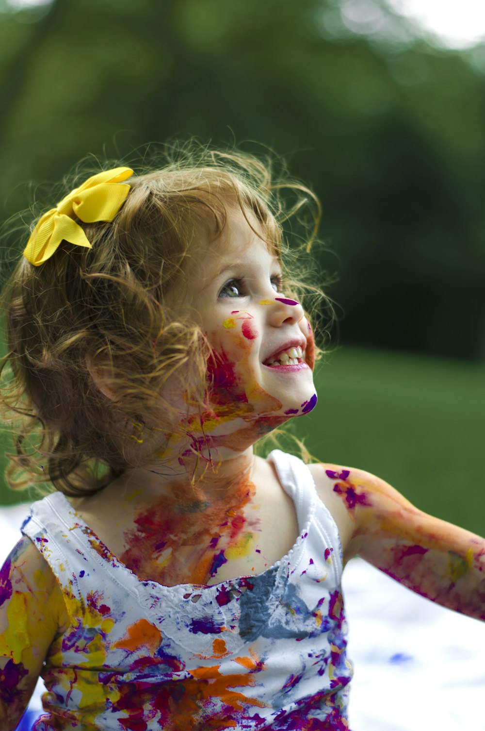 Toddler smiling with bright face paint